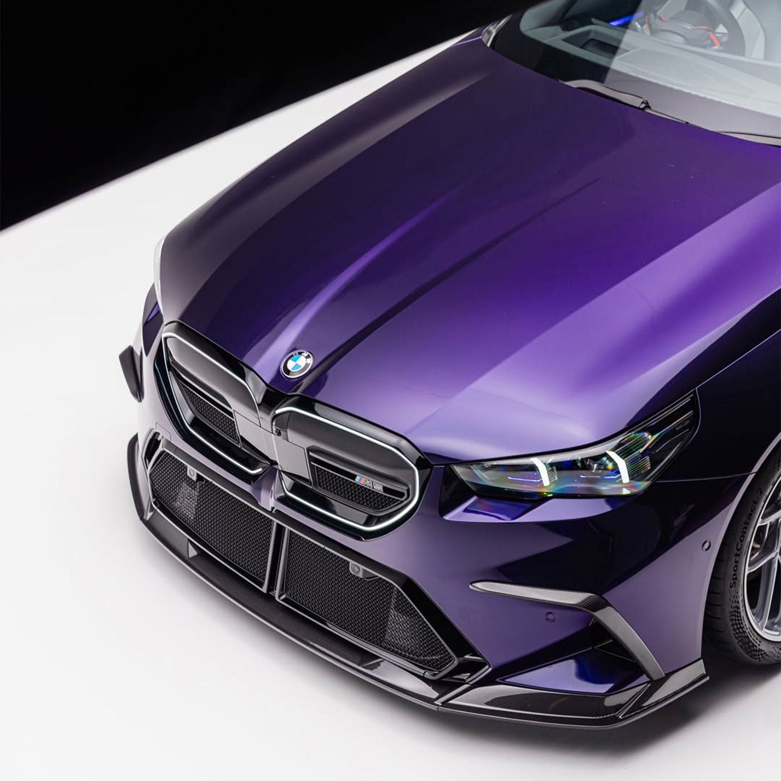 BMW M5 wrapped in Glossy Metallic Midnight Purple Color PPF front view.