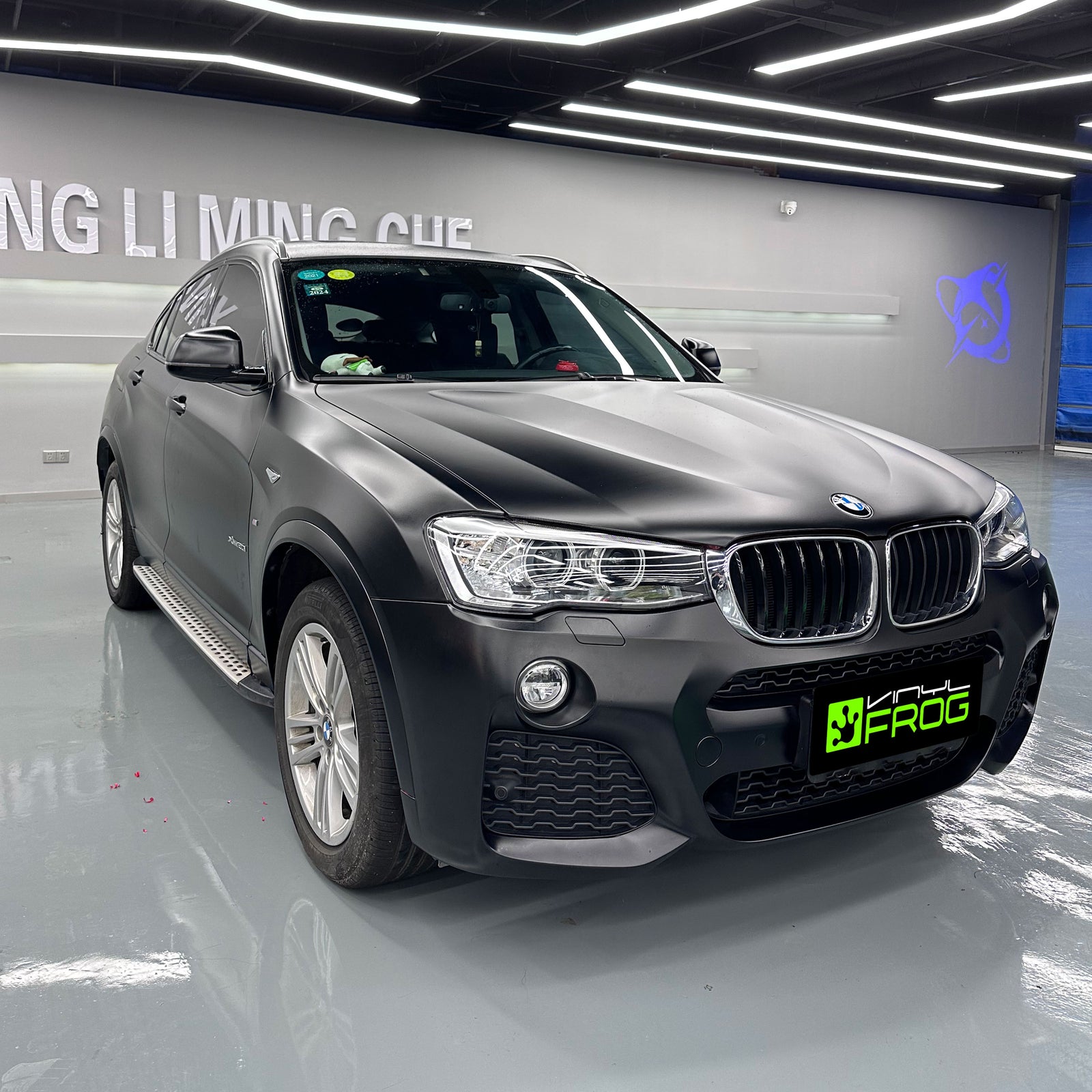 BMW X4 wrapped in Satin Black car Wrap.