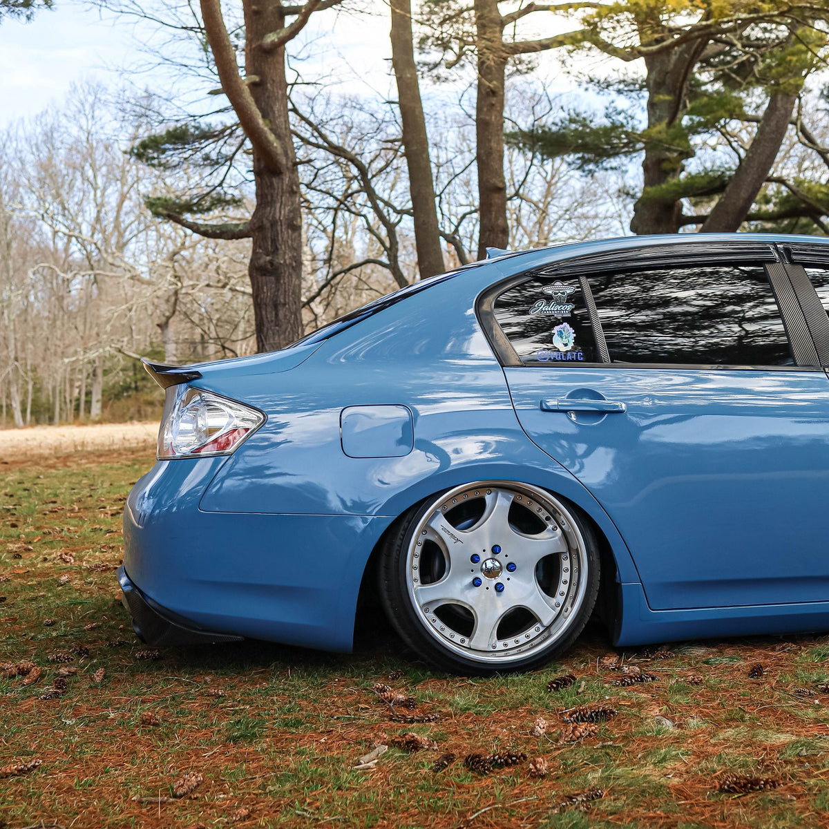 Rear side view of Super Glossy China Blue wrapped sedan
