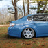 Rear side view of Super Glossy China Blue wrapped sedan