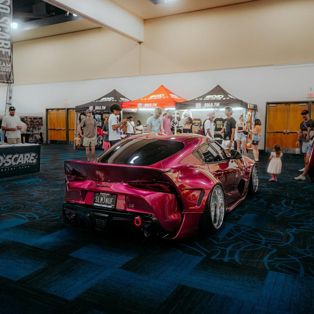 Toyota Supra wrapped in Glossy Metallic Rubellite Purple vinyl wrap back view 