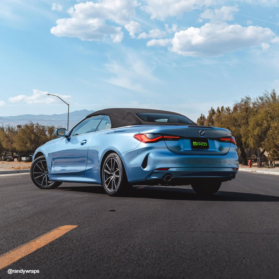 BMW 4 Series Convertible wrapped in Glossy Metallic Silver Lake Blue vinyl wrap back view.