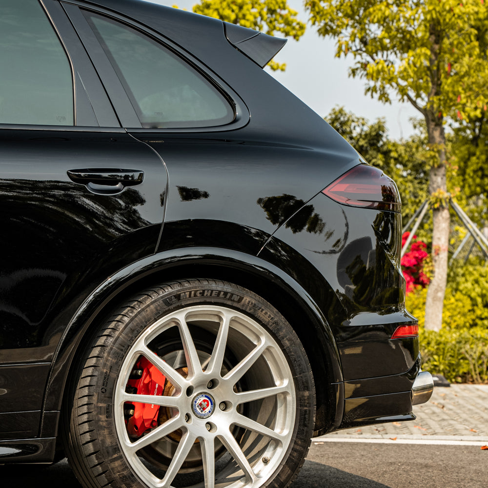 Porsche Cayenne wrapped in High Glossy Paint Black vinyl wrap side view.