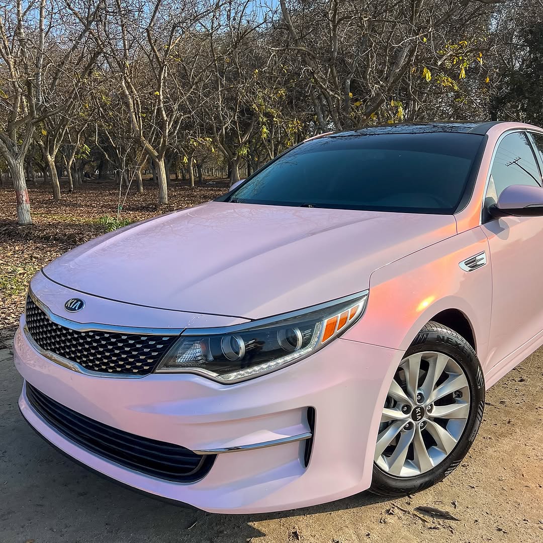 Kia Optima wrapped in Candy Metallic Pink White vinyl wrap.