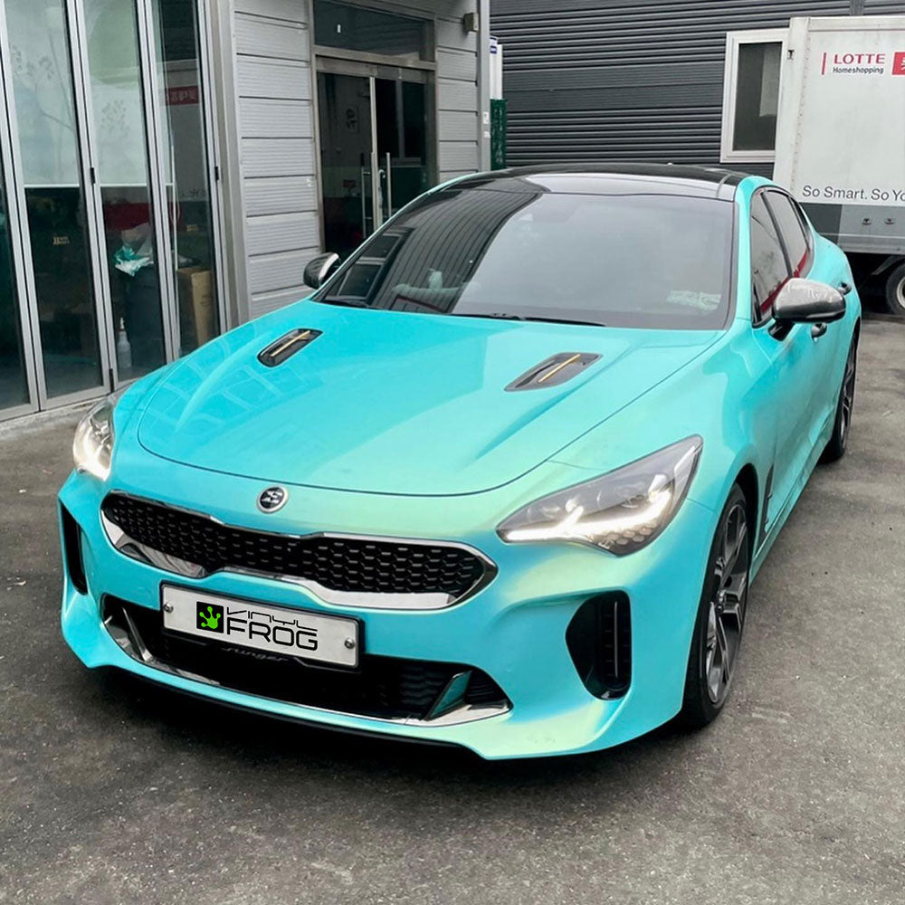 Kia Stinger wrapped in Candy Metallic Neon Ice Blue vinyl wrap.