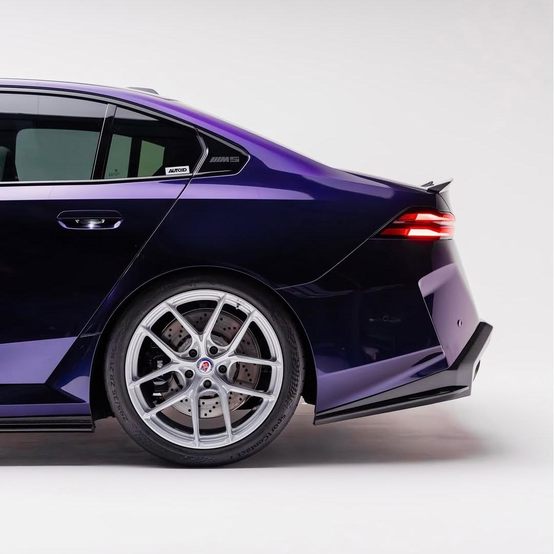 BMW M5 wrapped in Glossy Metallic Midnight Purple Color PPF door view.