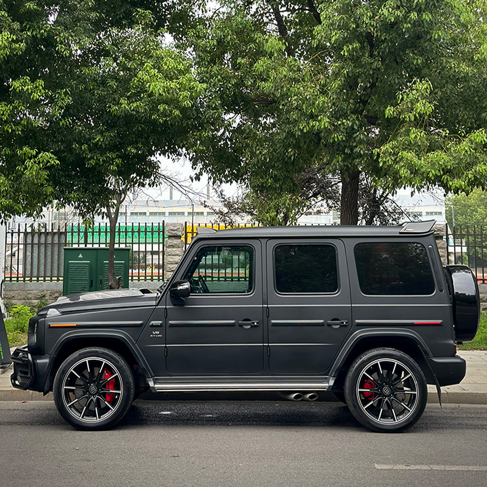 Mercedes-Benz G-Class wrapped in Satin Black Vinyl Wrap on road.