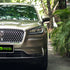 Lincoln SUV wrapped in Glossy Metallic Glitter Champagne / Millennium Jade vinyl wrap.