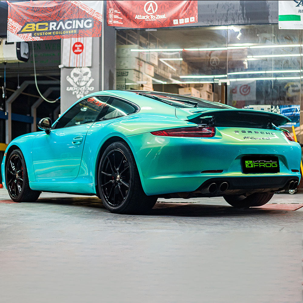 Porsche wrapped in Candy Metallic Neon Ice Blue vinyl wrap back view.
