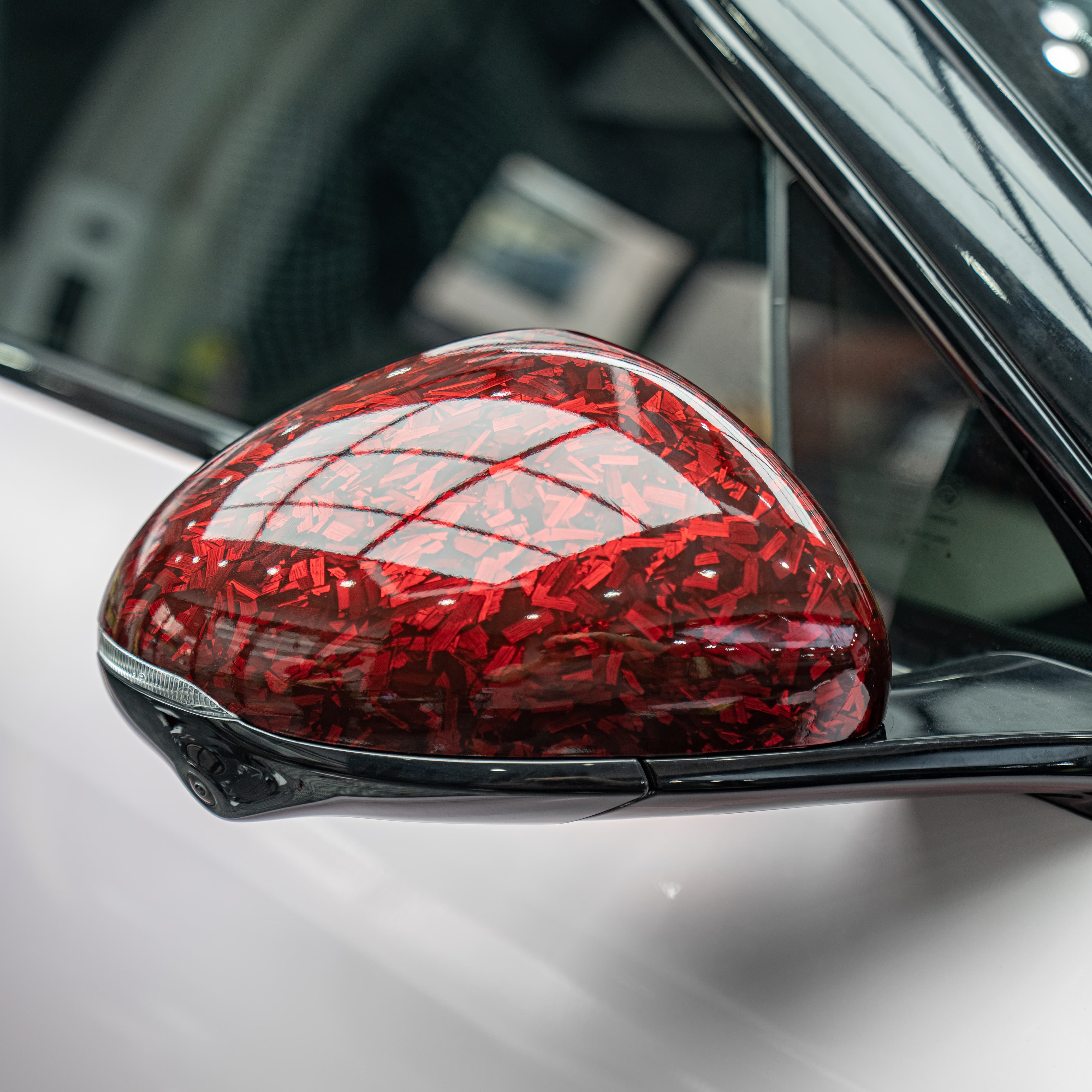 Close-up of car mirror with Red Forged Carbon Fiber Vinyl Wrap finish.