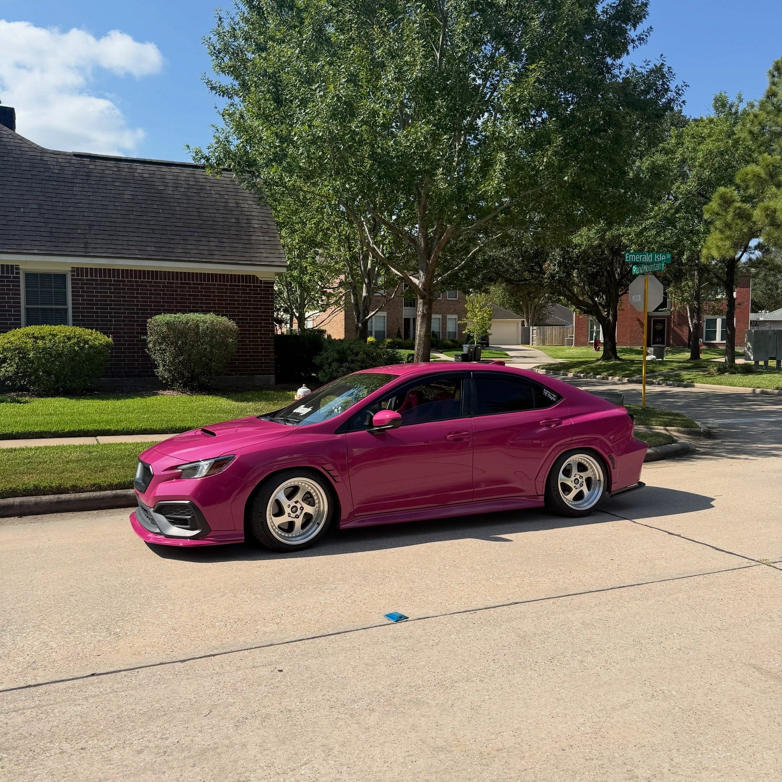 Side view of sedan wrapped in High Glossy Ruby Star Vinyl Wrap
