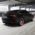 Tesla Model 3 wrapped in Matte Silk Black Vinyl Wrap on road.