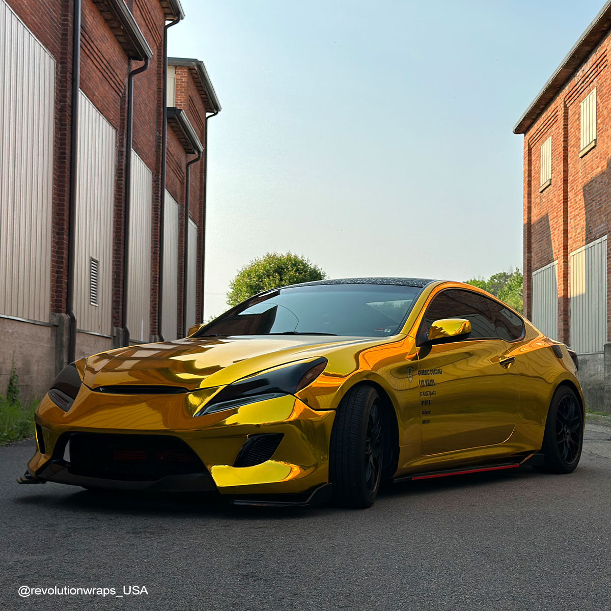 Toyota GR86 wrapped in Mirror Chrome Gold vinyl wrap on road.