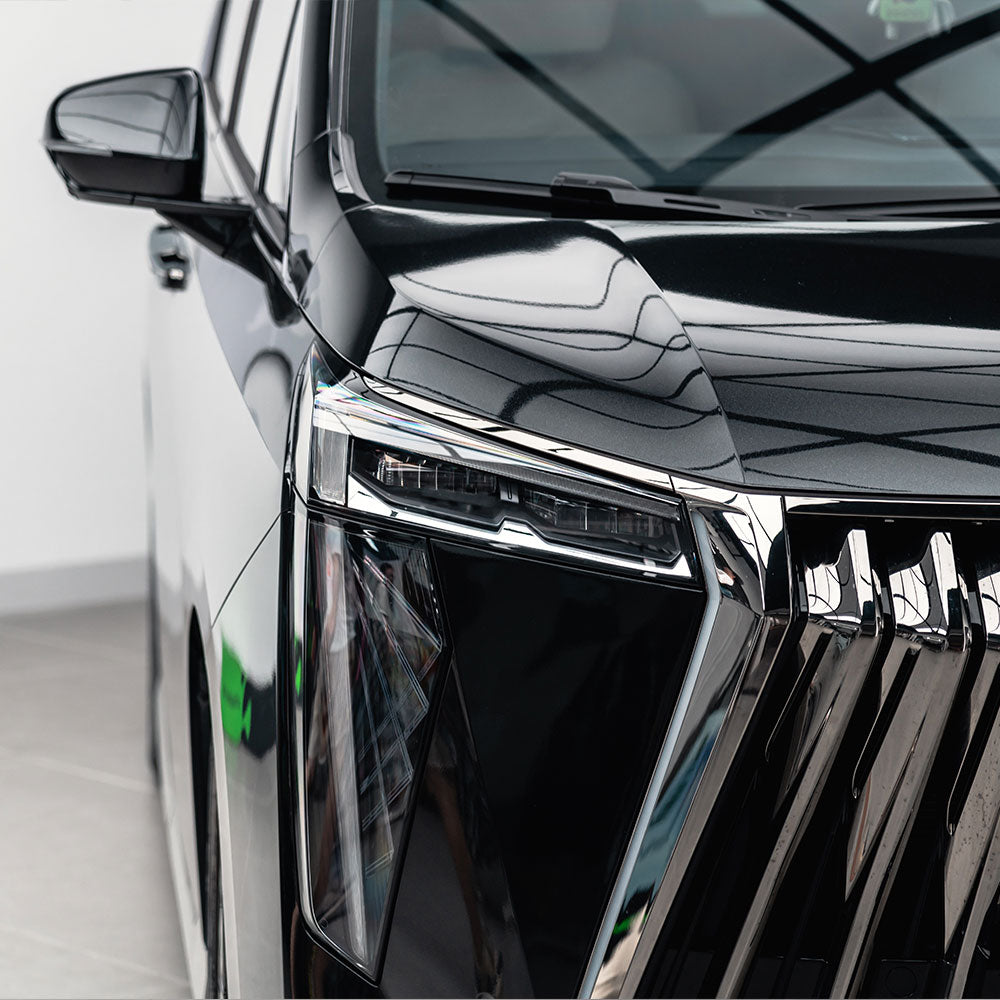 Toyota SUV wrapped in Glossy Metallic Metal Black vinyl wrap.
