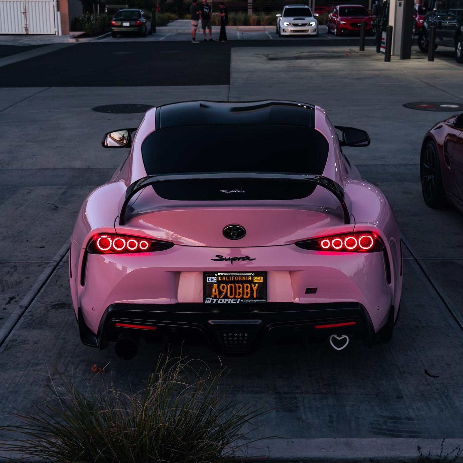 Toyota Supra wrapped in High Glossy Baby Pink vinyl wrap back view.