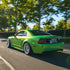 Ford Mustang Shelby GT500 wrapped in Candy Metallic Neon Green vinyl wrap on road.