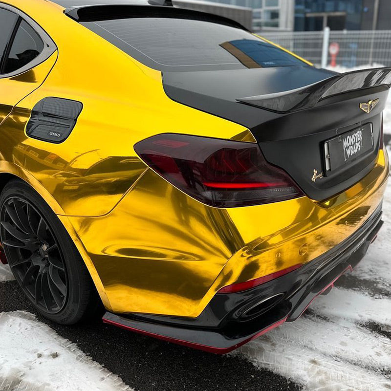 Genesis G70 wrapped in Mirror Chrome Gold vinyl wrap back view.