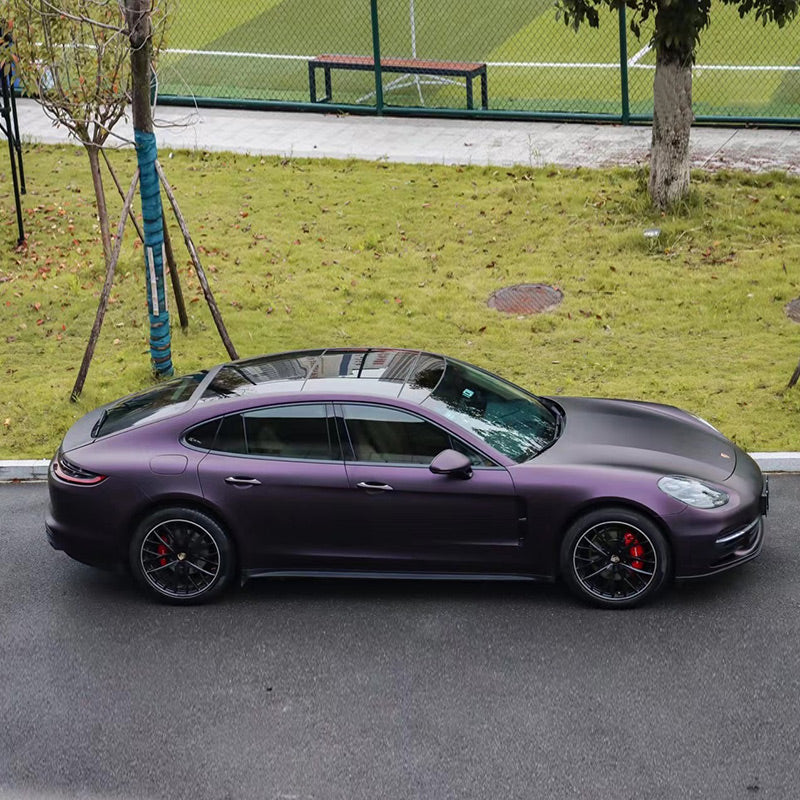 Porsche Panamera wrapped in Matte Metallic Black Purple vinyl wrap upper view.