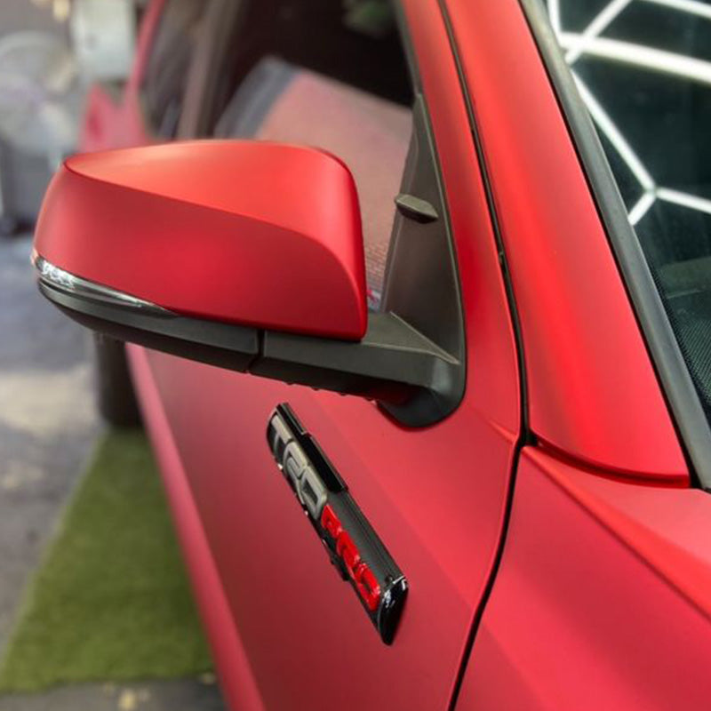 Toyota Tacoma wrapped in Satin Chrome Prismatic Red vinyl wrap side mirror.