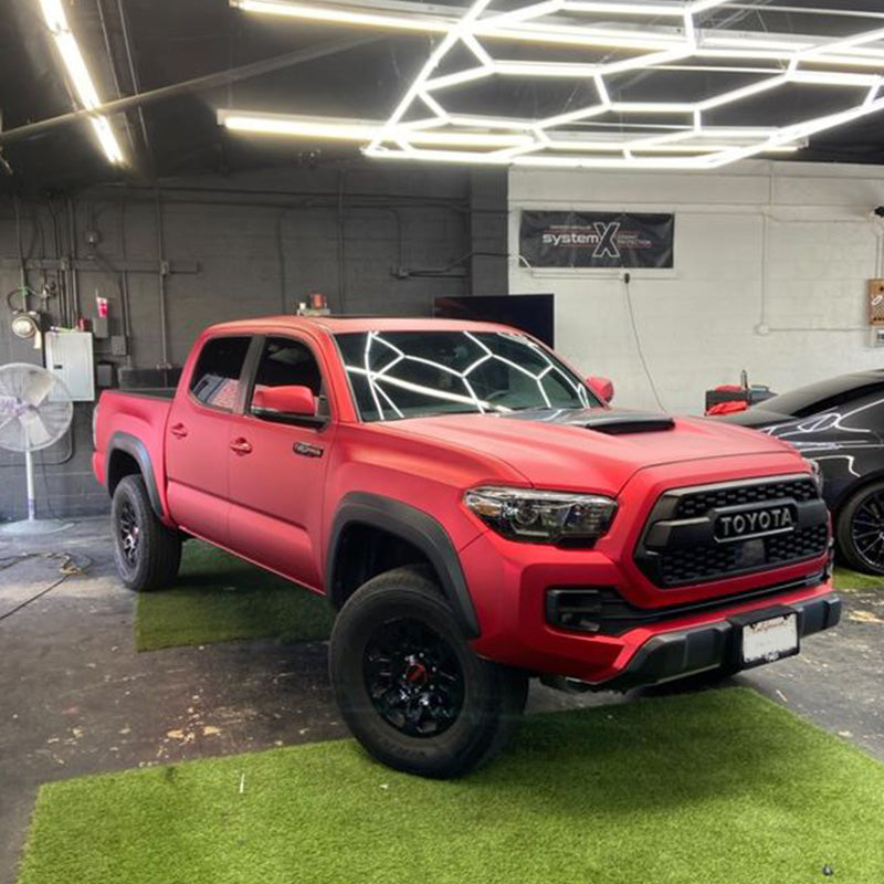 Toyota Tacoma wrapped in Satin Chrome Prismatic Red vinyl wrap.